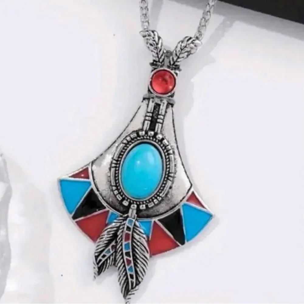 Bohemian Silver Pendant Necklace with Turquoise and Red Accents.